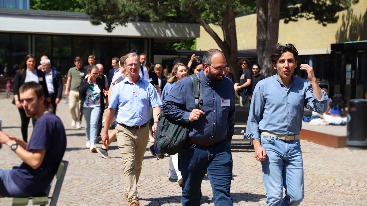 Associate professor Nika Akopian walking with a delegation from a quantum conference